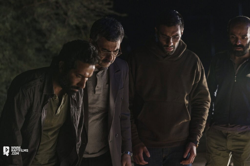 Banipal Shoomon and cast in a tense night scene from the Iranian film “Cause of Death: Unknown,” directed by Ali Zarnegar.